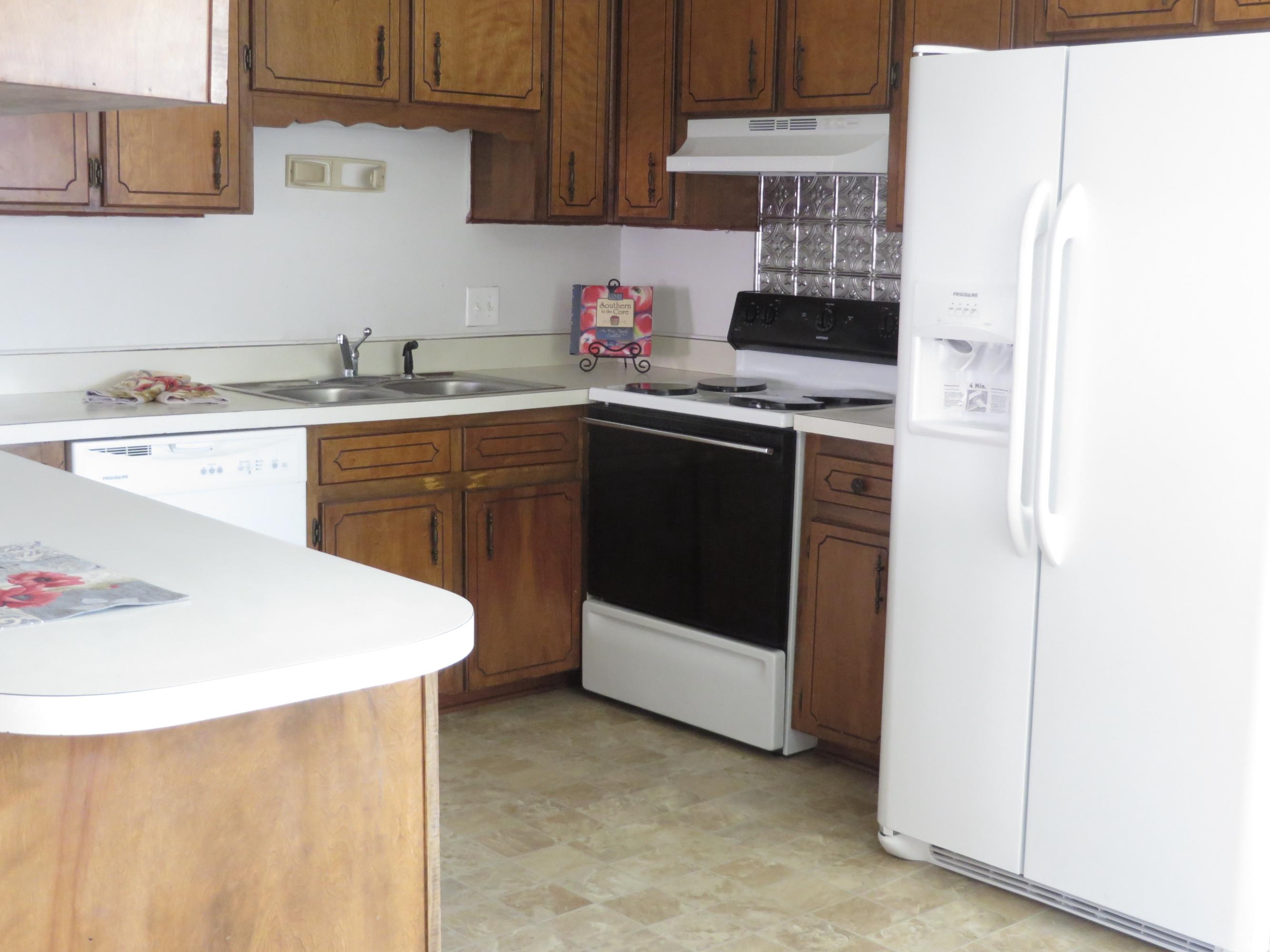 135 Perdido Circle Niceville, FL 32578 - Photo 25 of 28 a kitchen with stainless steel appliances a stove a sink and white cabinets