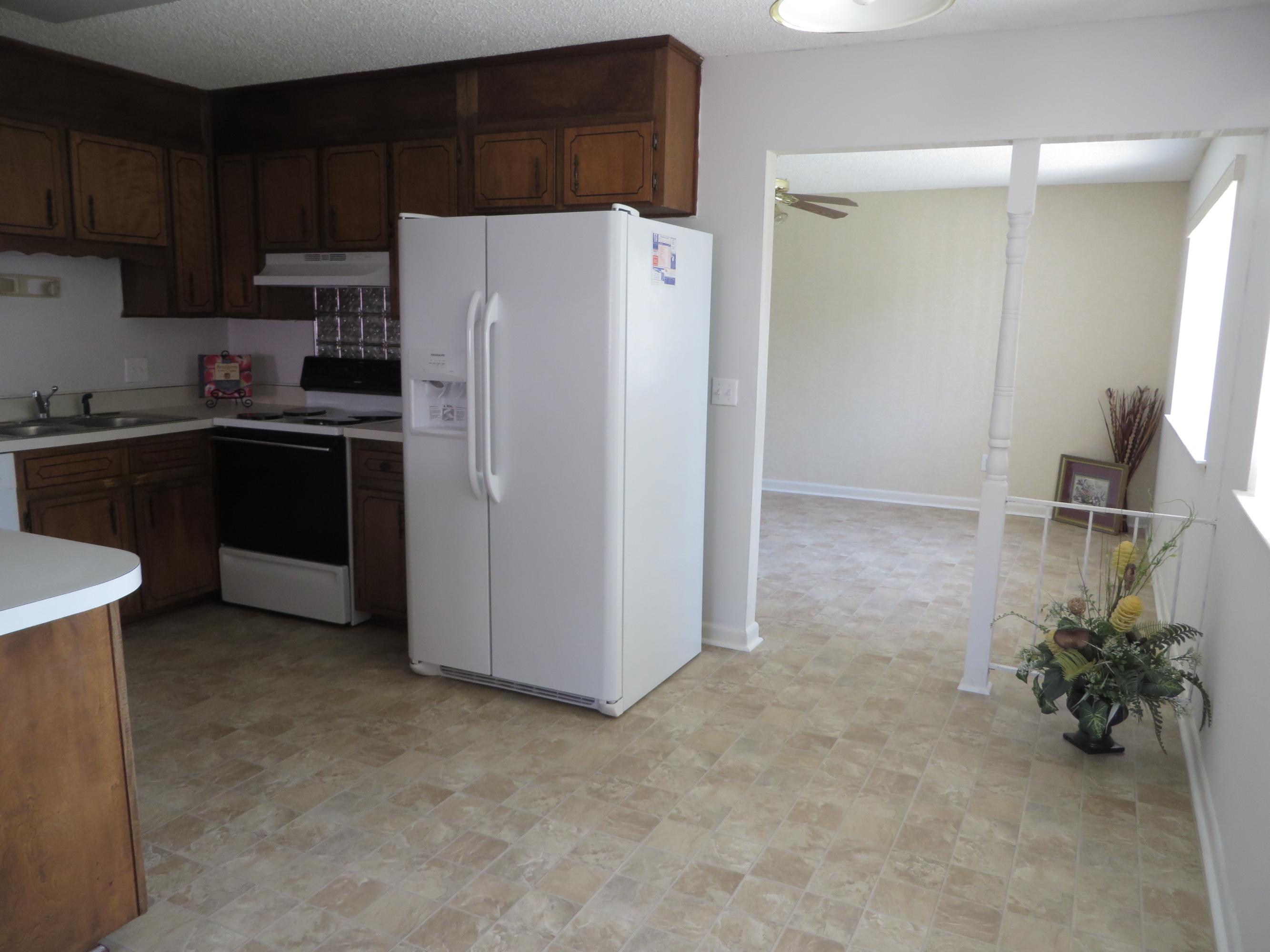 135 Perdido Circle Niceville, FL 32578 - Photo 26 of 28 a kitchen with a refrigerator and a sink