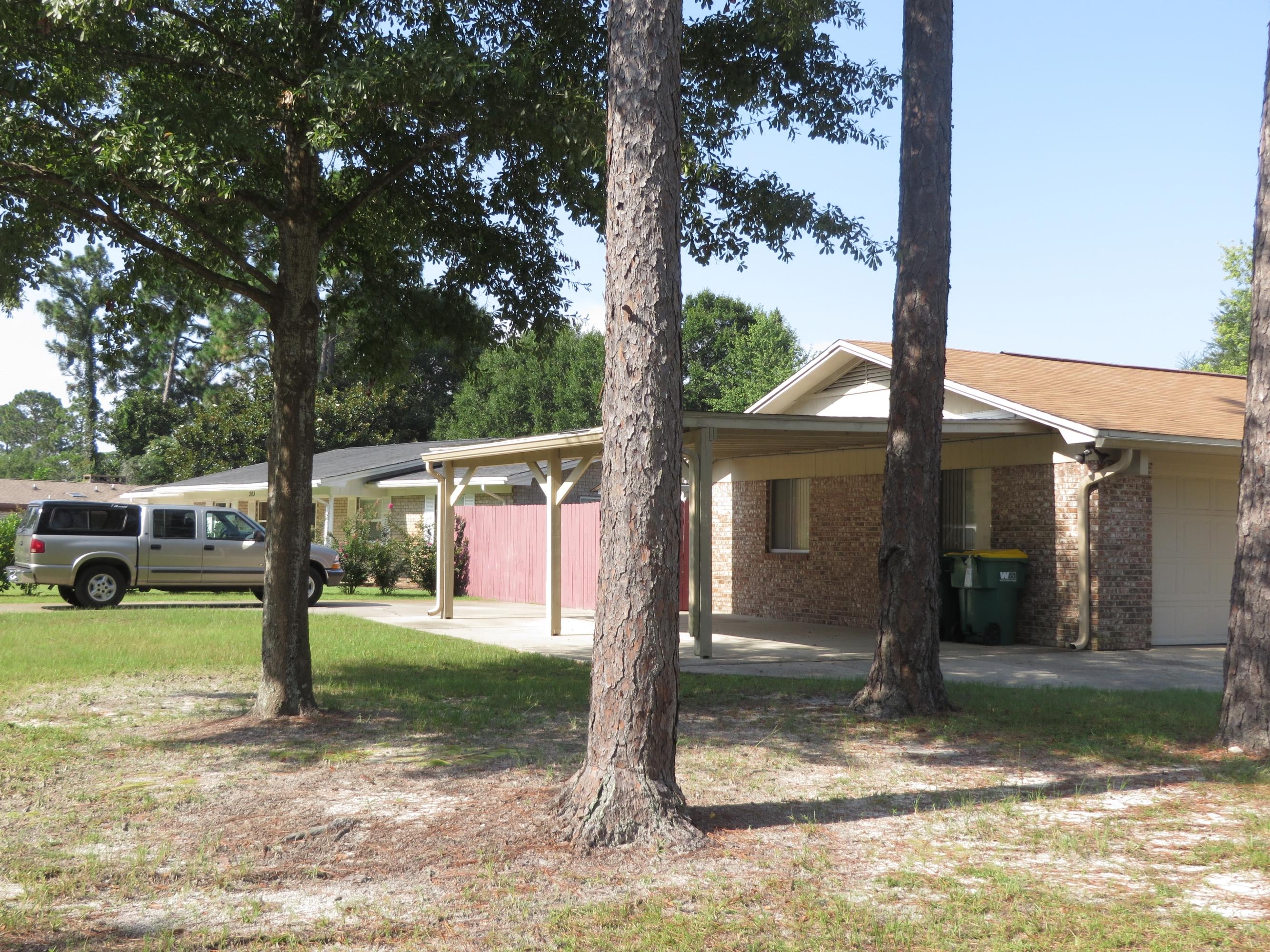 135 Perdido Circle Niceville, FL 32578 - Photo 28 of 28 a view of a house with backyard porch and sitting area