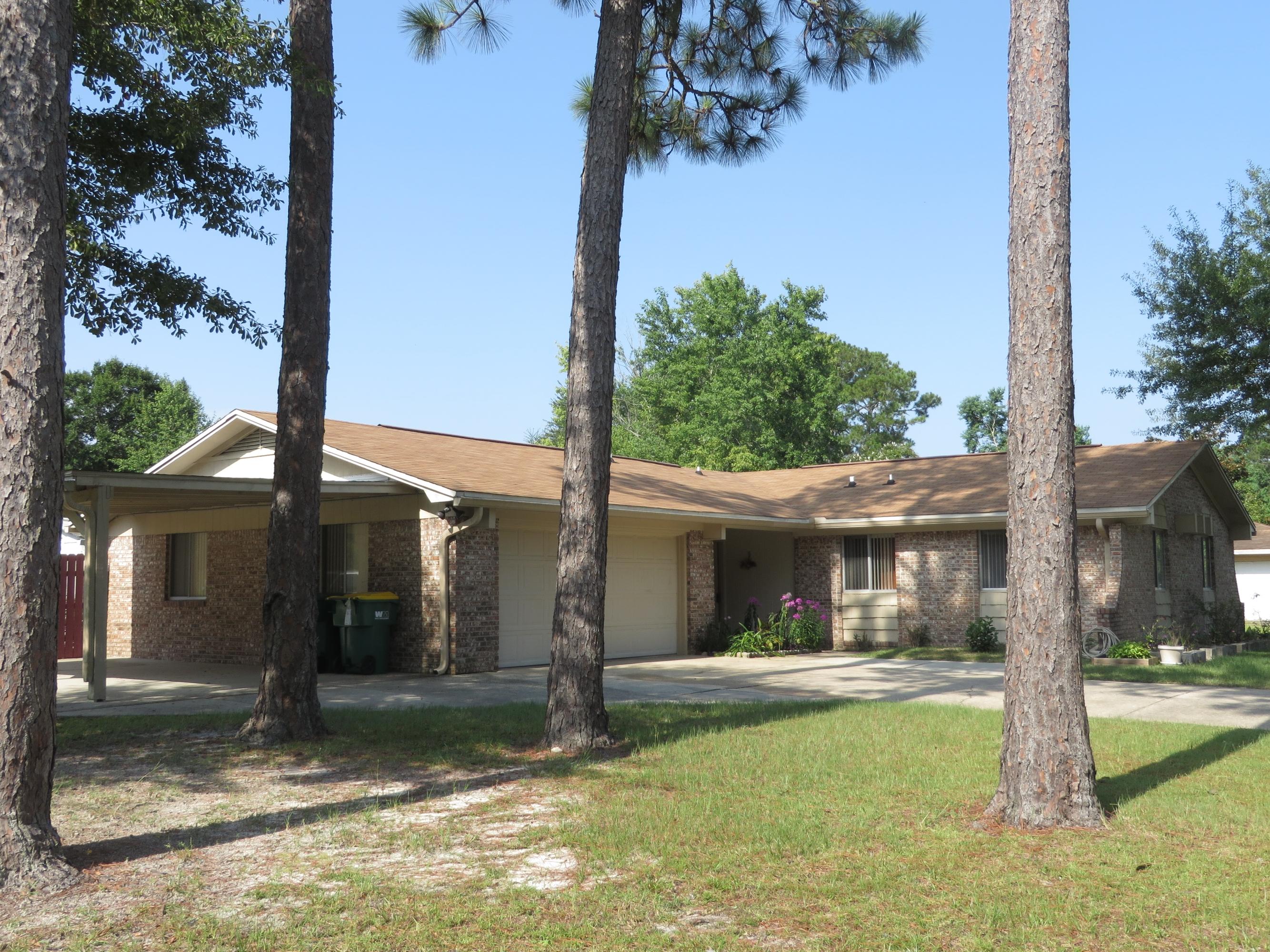 135 Perdido Circle Niceville, FL 32578 - Photo 3 of 28 a view of a house with backyard porch and sitting area