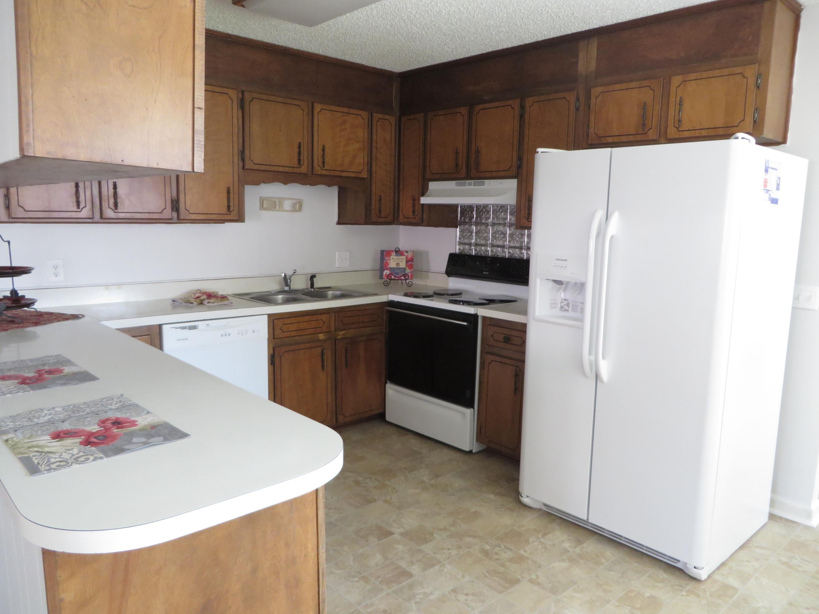 135 Perdido Circle Niceville, FL 32578 - Photo 5 of 28 a kitchen with a sink a stove and refrigerator