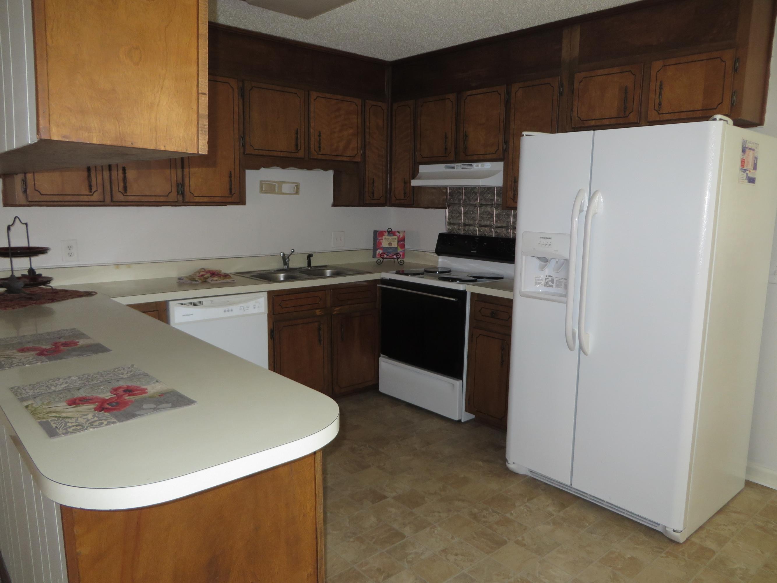 135 Perdido Circle Niceville, FL 32578 - Photo 6 of 28 a kitchen with stainless steel appliances a refrigerator a sink and white cabinets
