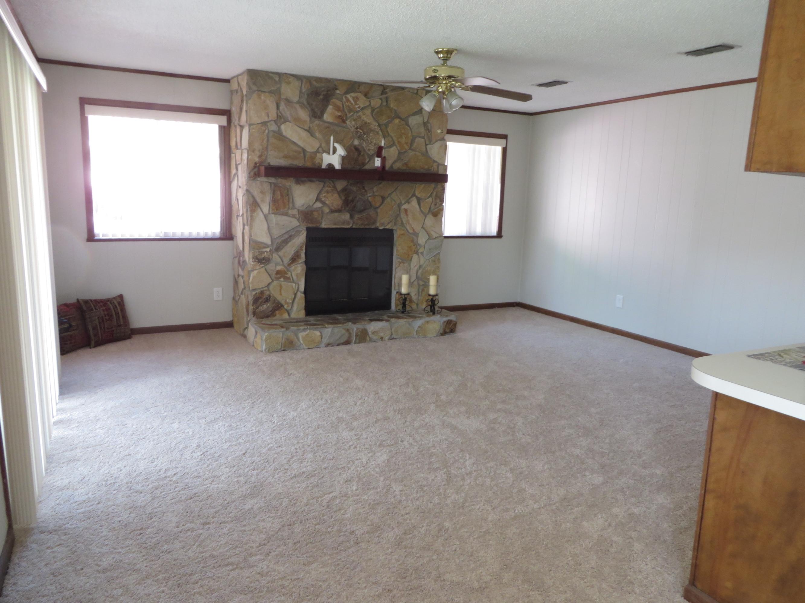 135 Perdido Circle Niceville, FL 32578 - Photo 9 of 28 an empty room with windows and fireplace