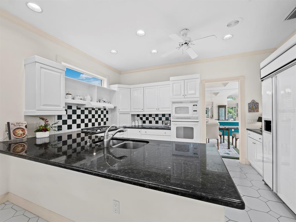 3543 Mistletoe Lane Longboat Key, FL 34228 - Photo 13 of 55 a kitchen with stainless steel appliances granite countertop a sink and cabinets