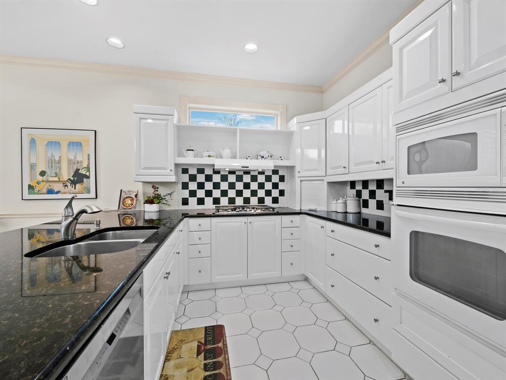 3543 Mistletoe Lane Longboat Key, FL 34228 - Photo 14 of 55 a kitchen with granite countertop a sink a stove and cabinets