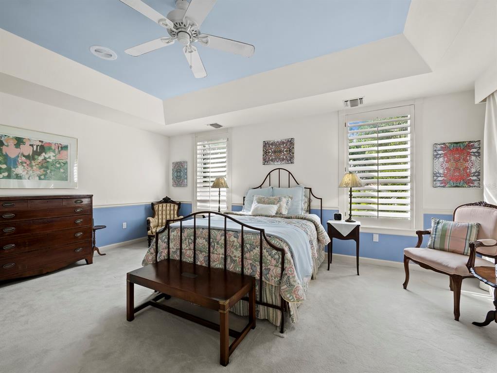 3543 Mistletoe Lane Longboat Key, FL 34228 - Photo 16 of 55 a bedroom with a bed a couch and a dresser