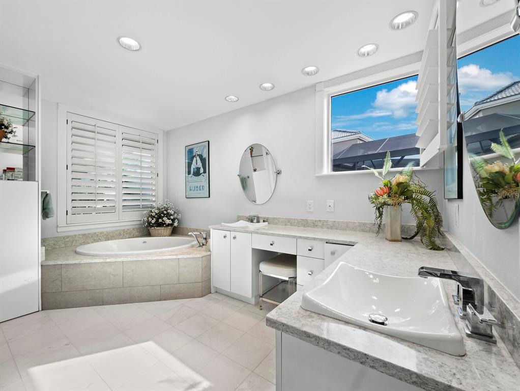 3543 Mistletoe Lane Longboat Key, FL 34228 - Photo 17 of 55 a bathroom with a tub sink toilet and mirror