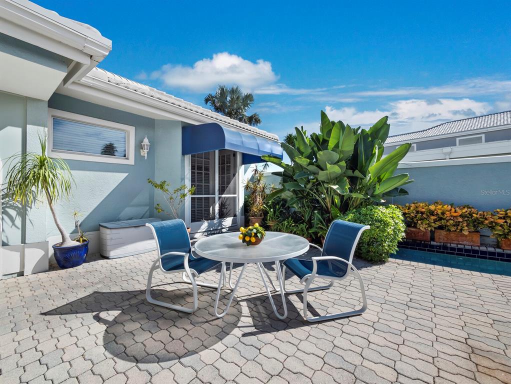3543 Mistletoe Lane Longboat Key, FL 34228 - Photo 21 of 55 a view of a patio with plants and table and chairs