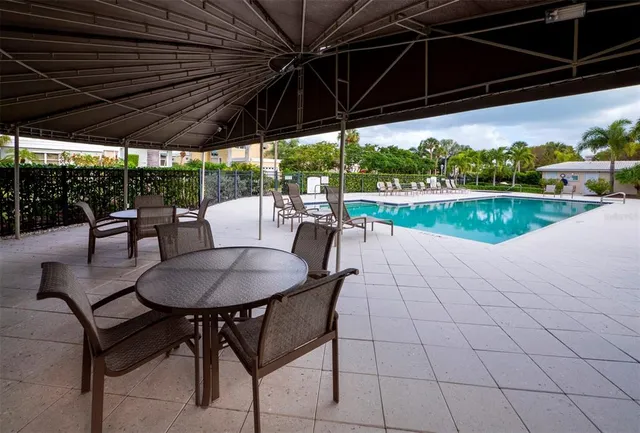 a swimming pool with outdoor seating and yard