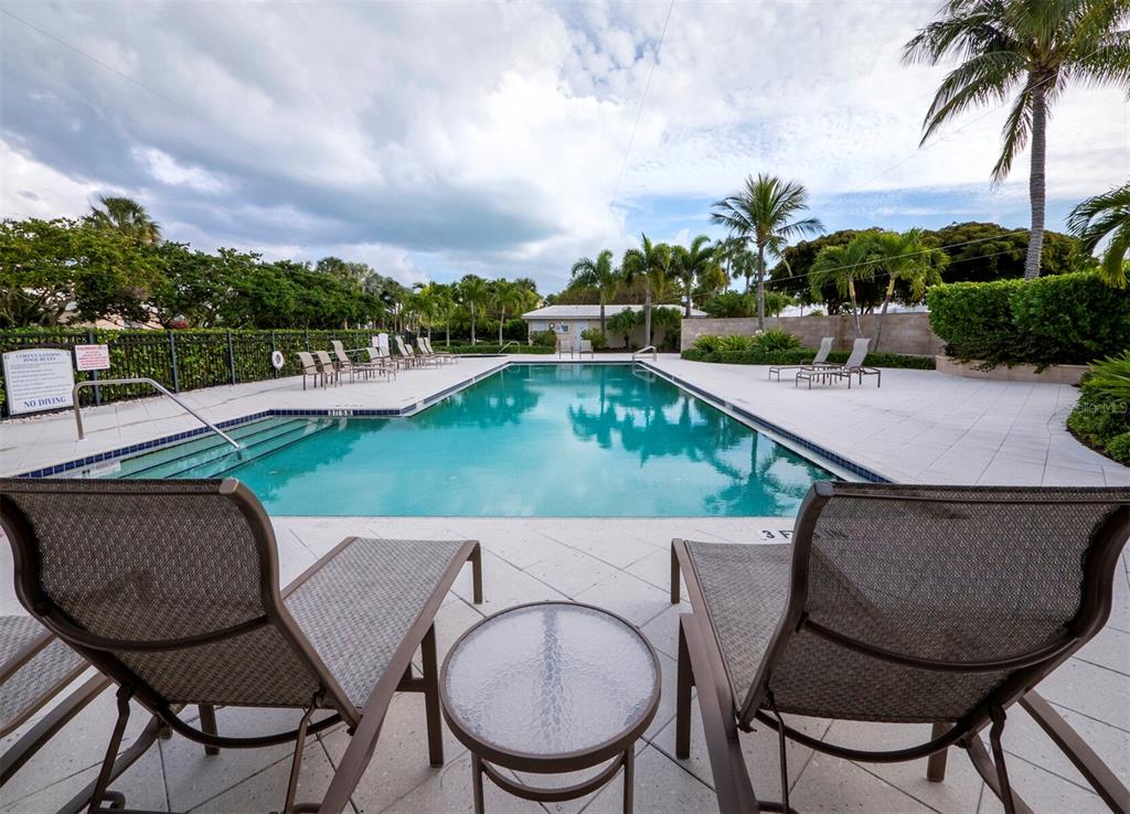 3543 Mistletoe Lane Longboat Key, FL 34228 - Photo 31 of 55 a swimming pool with outdoor seating and yard