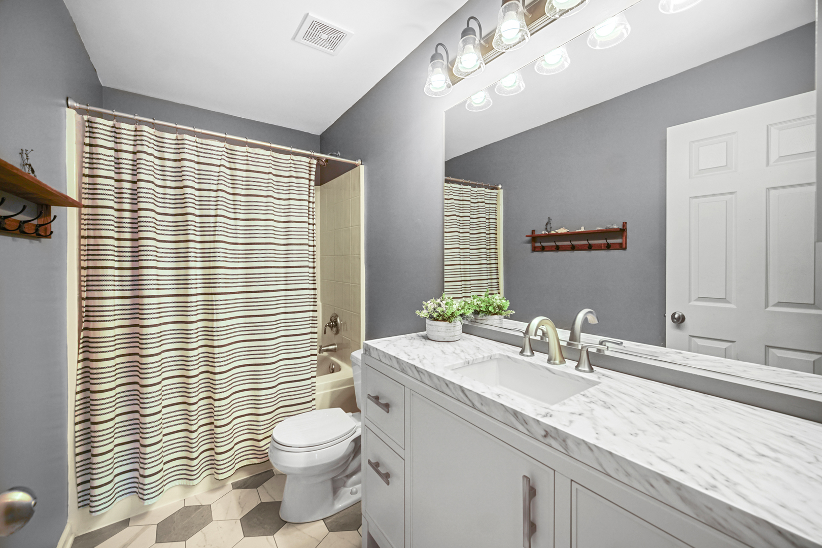 1826 Prairie Ridge Circle Lindenhurst, IL 60046 - Photo 21 of 39 a bathroom with a granite countertop sink a toilet and shower curtain