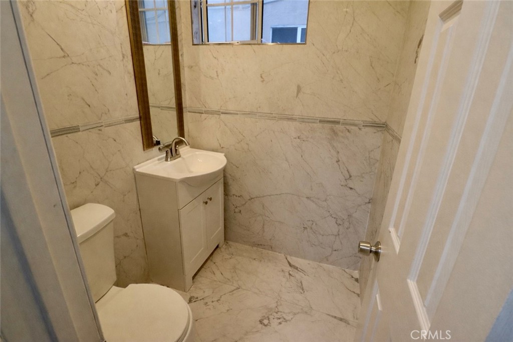 13438 Obispo Avenue Paramount, CA 90723 - Photo 12 of 14 a bathroom with a sink a toilet and shower