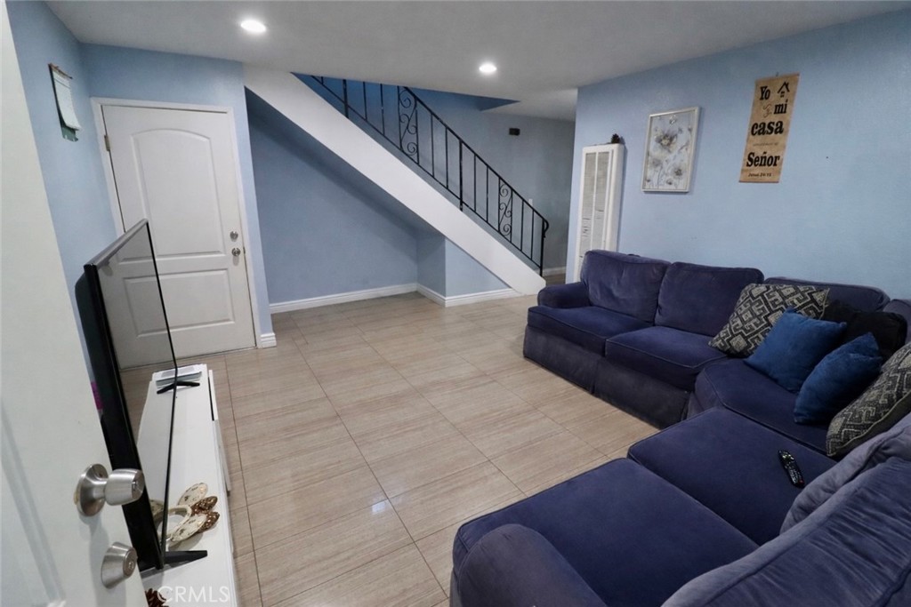13438 Obispo Avenue Paramount, CA 90723 - Photo 4 of 14 a living room with furniture and a flat screen tv