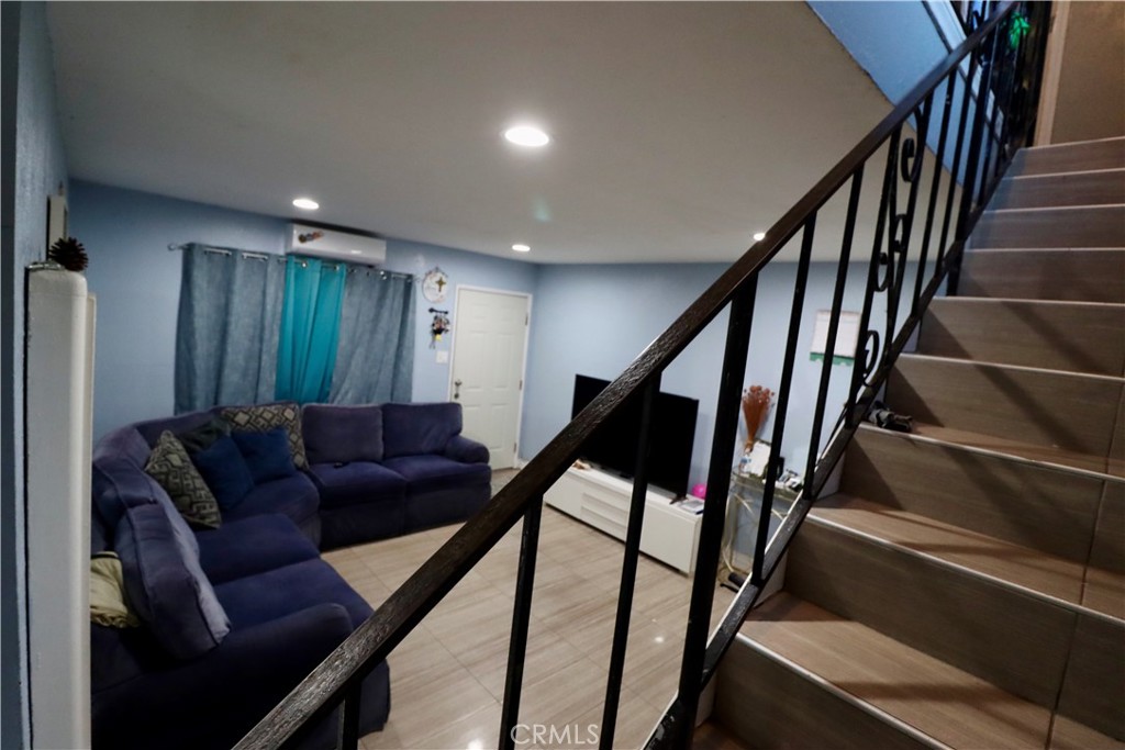 13438 Obispo Avenue Paramount, CA 90723 - Photo 7 of 14 a living room with furniture and stairs