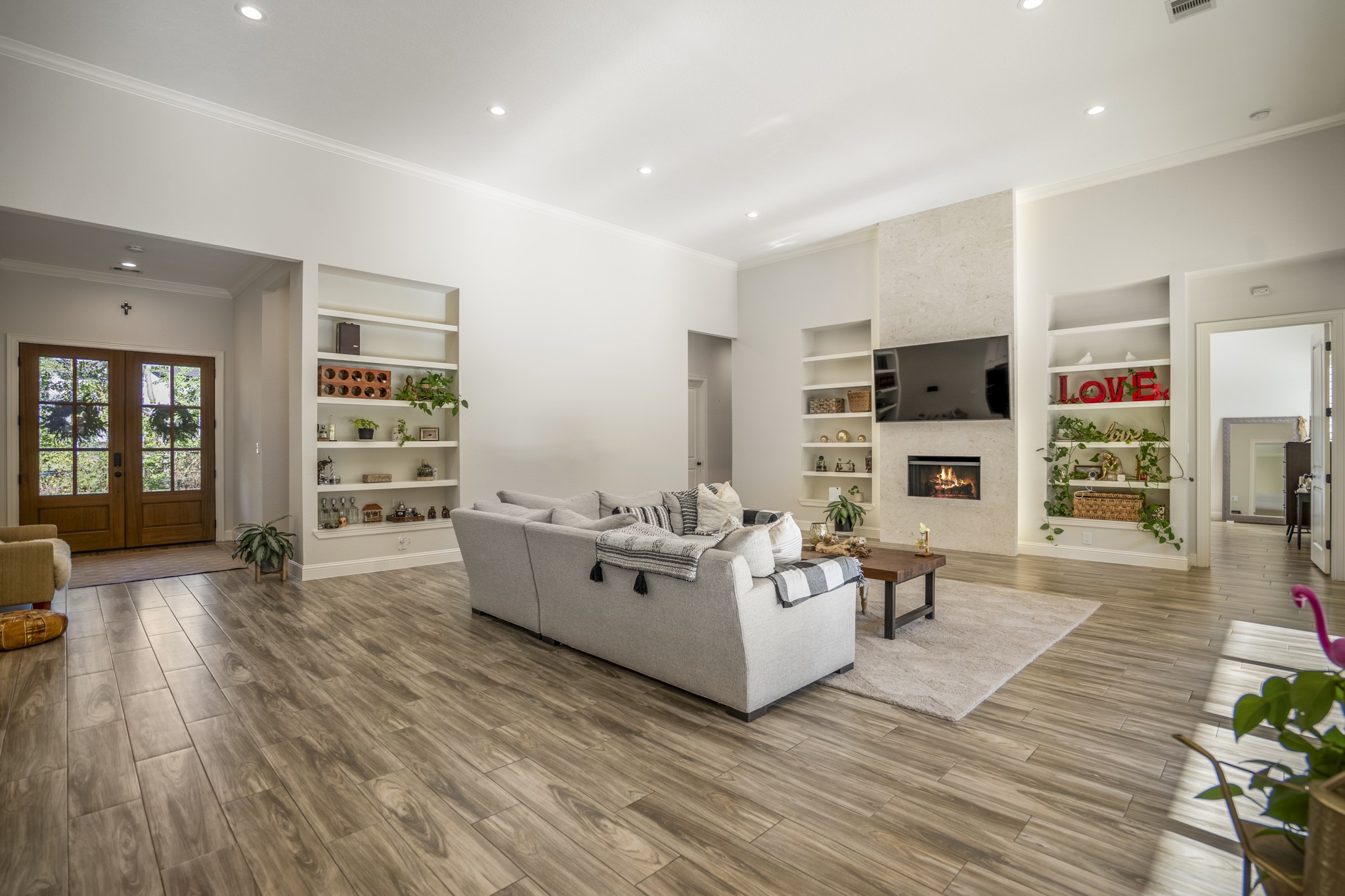 25202 Wilkes Park Road Tomball, TX 77375 - Photo 12 of 50 Stunning fireplace wrapped in natural travertine tile adds warm texture and luxury to the heart of the home.