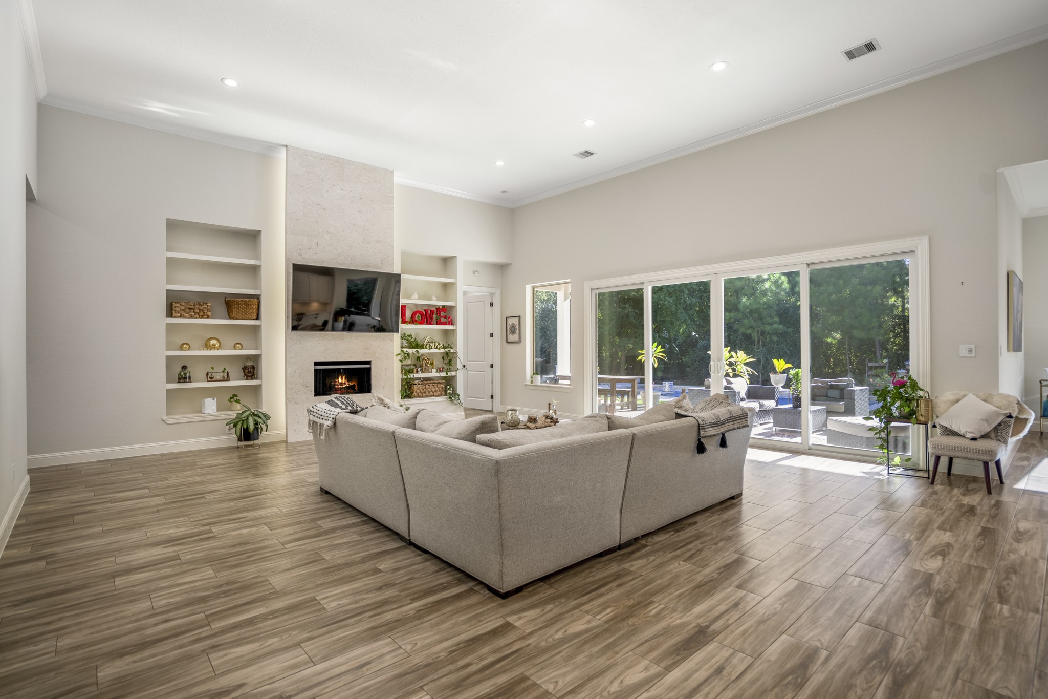 25202 Wilkes Park Road Tomball, TX 77375 - Photo 13 of 50 Oversized windows bathe the space in daylight while framing private wooded views.