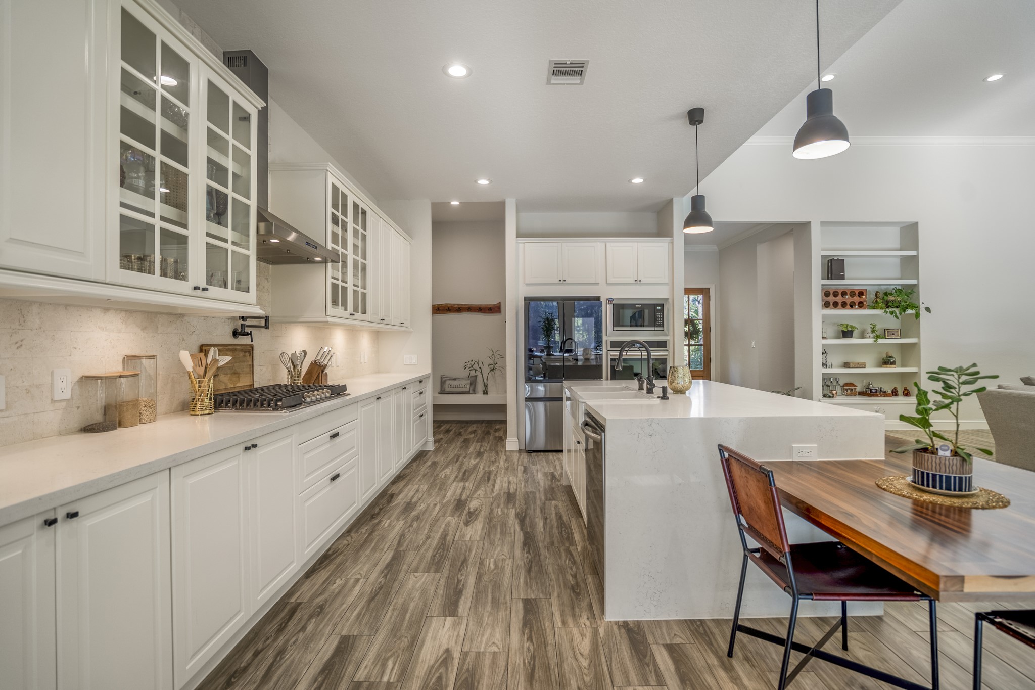 25202 Wilkes Park Road Tomball, TX 77375 - Photo 18 of 50 Sleek gas cooktop paired with a pot filler enhances convenience and culinary capability. There is a Culligan whole-home water softener and filtration system plus RO drinking water tap deliver exceptional water quality.