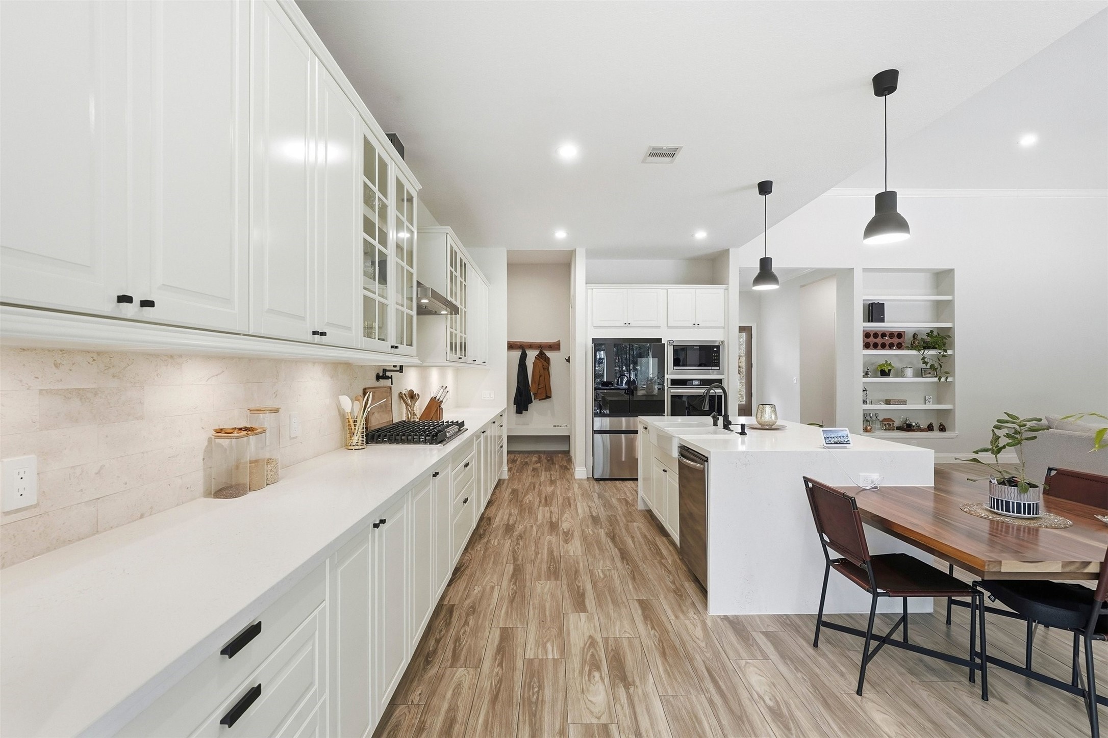 25202 Wilkes Park Road Tomball, TX 77375 - Photo 20 of 47 a kitchen with stainless steel appliances kitchen island granite countertop a sink dishwasher a stove and white cabinets with wooden floor