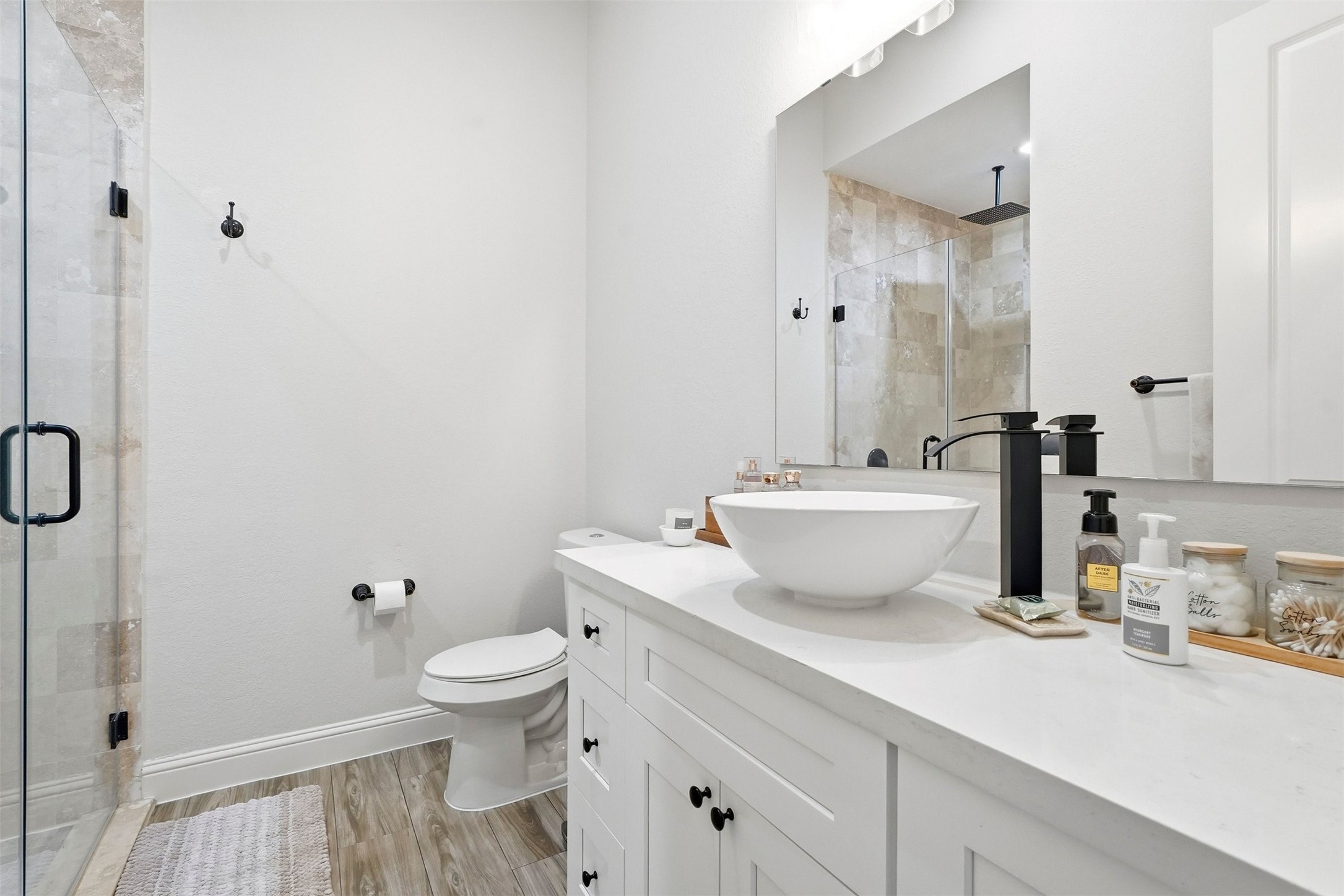 25202 Wilkes Park Road Tomball, TX 77375 - Photo 28 of 47 a bathroom with a granite countertop sink a toilet and a shower