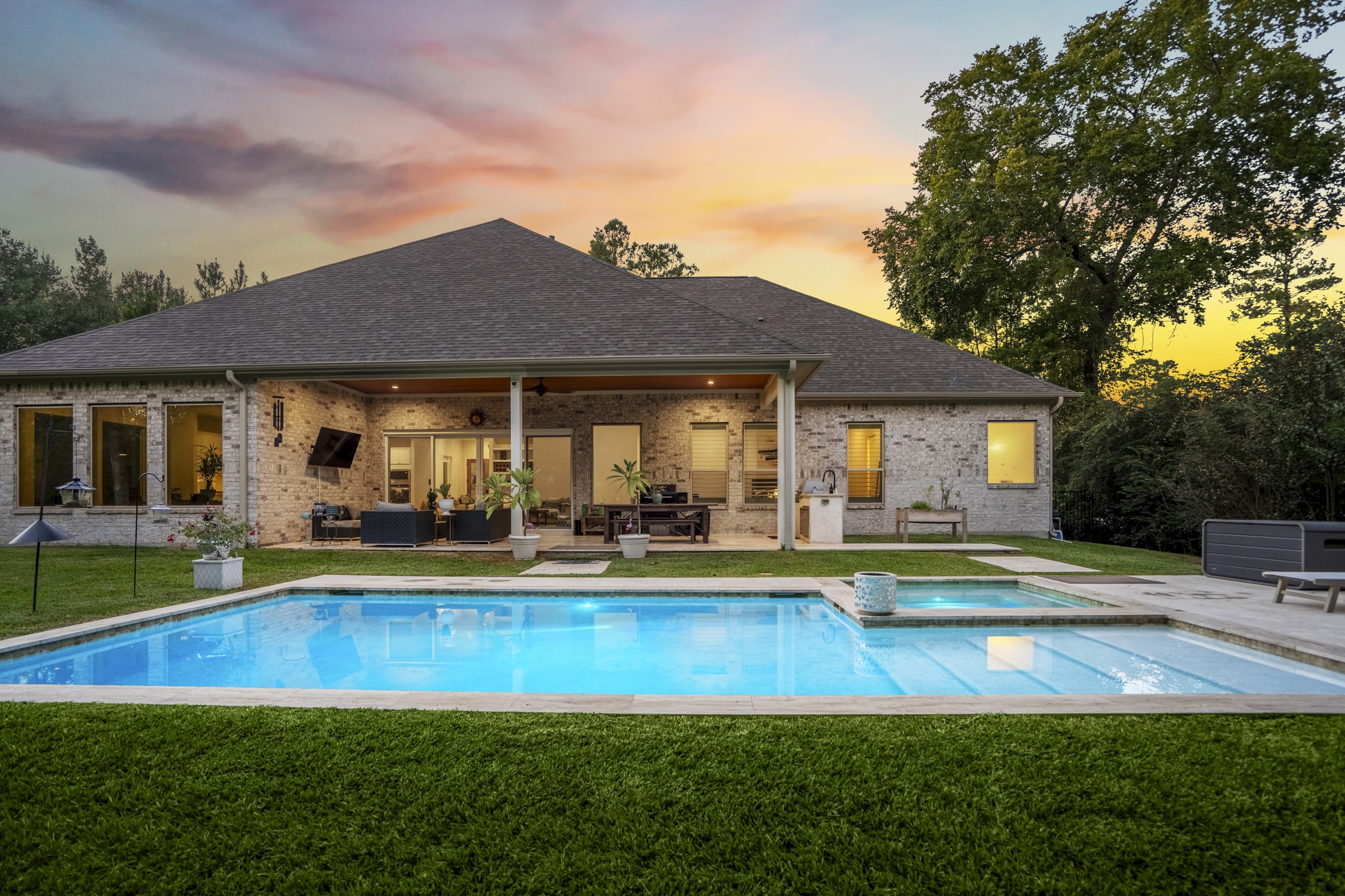 25202 Wilkes Park Road Tomball, TX 77375 - Photo 3 of 50 Resort inspired pool sits privately behind the home, surrounded by green space and mature trees.