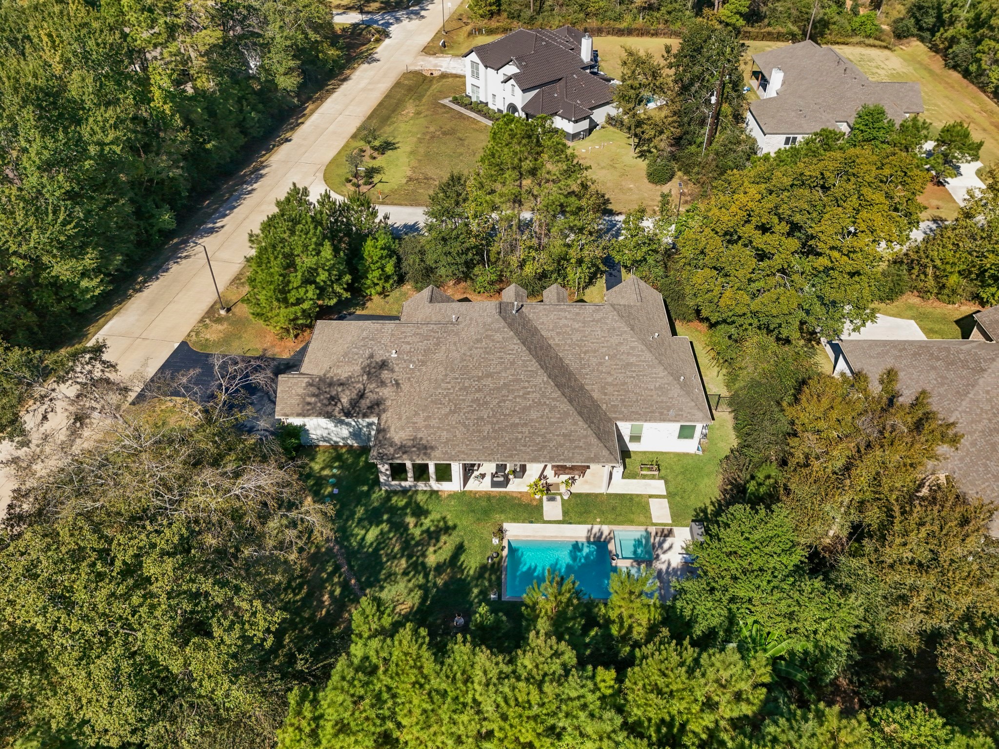 25202 Wilkes Park Road Tomball, TX 77375 - Photo 34 of 50 Striking aerial captures the luxury pool area and wooded privacy.
