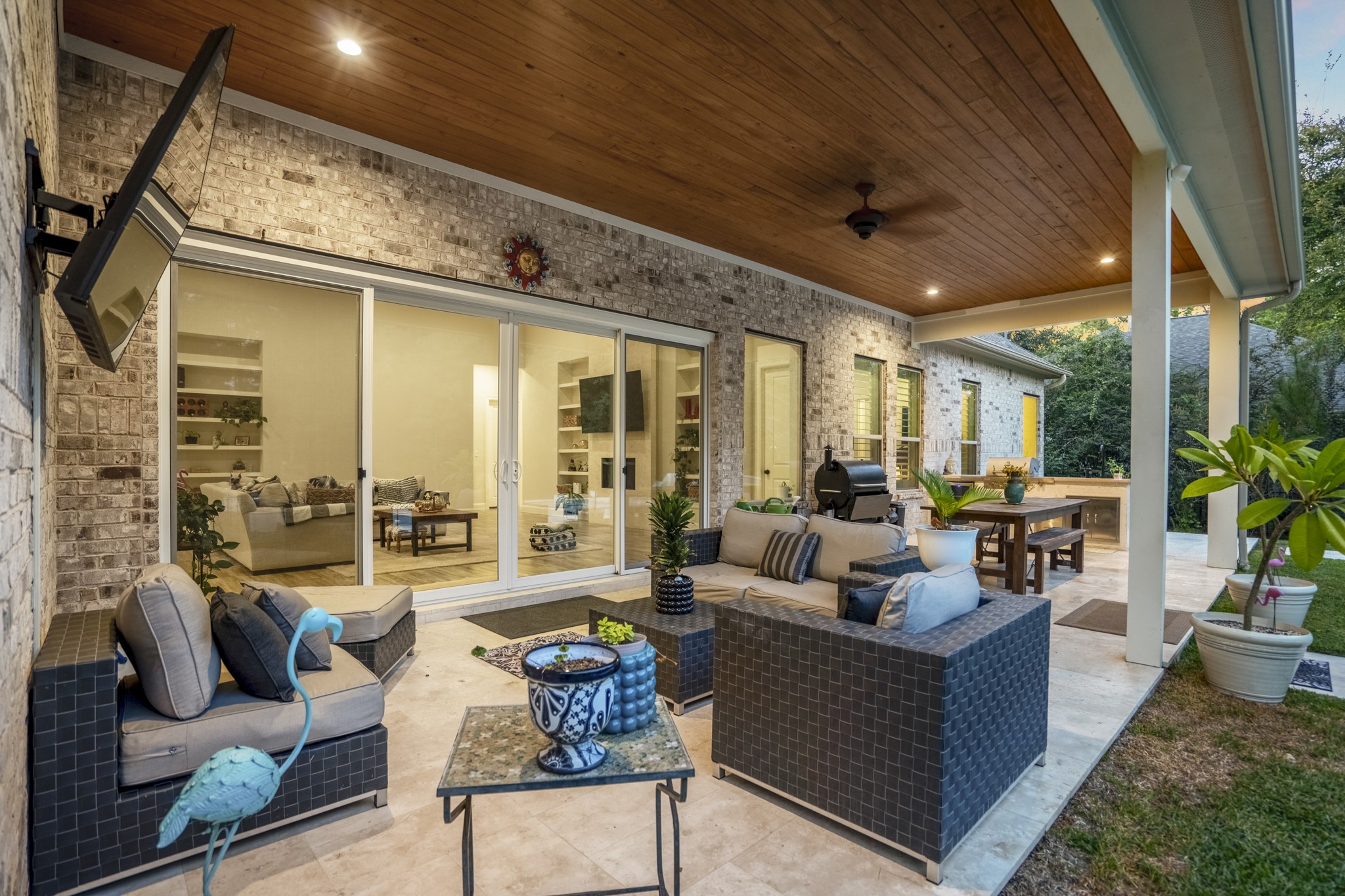 25202 Wilkes Park Road Tomball, TX 77375 - Photo 36 of 50 Upgraded travertine patio creates a sophisticated outdoor living surface that stays cool and enhances the backyard retreat.