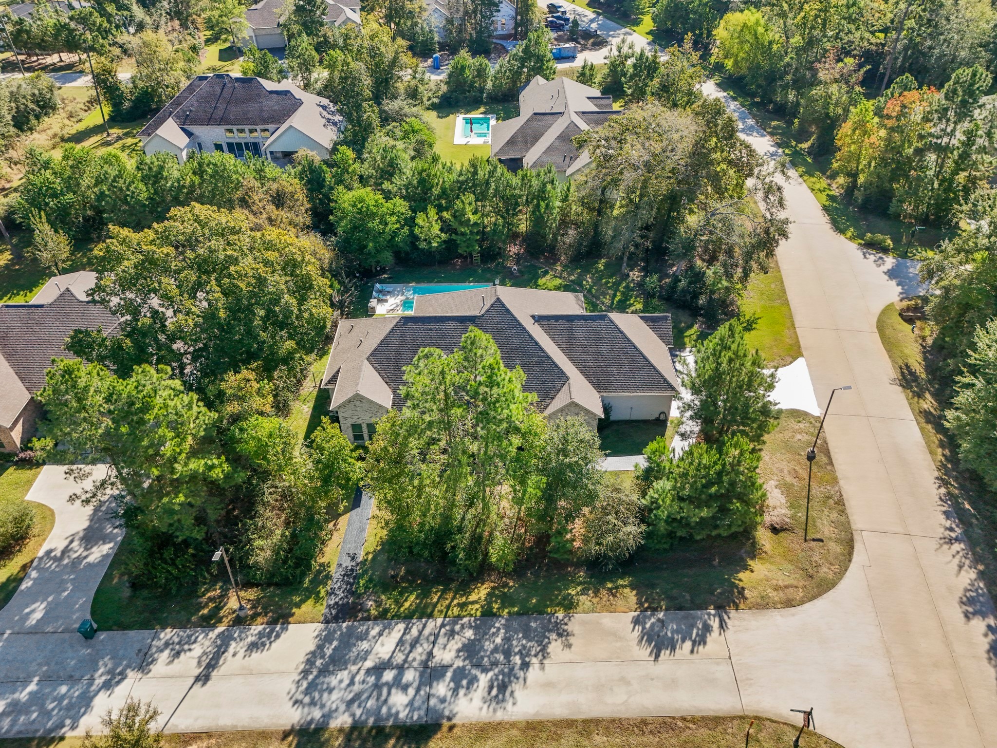 25202 Wilkes Park Road Tomball, TX 77375 - Photo 4 of 50 Beautiful curb appeal on a peaceful street with towering trees framing the property for a serene natural setting.