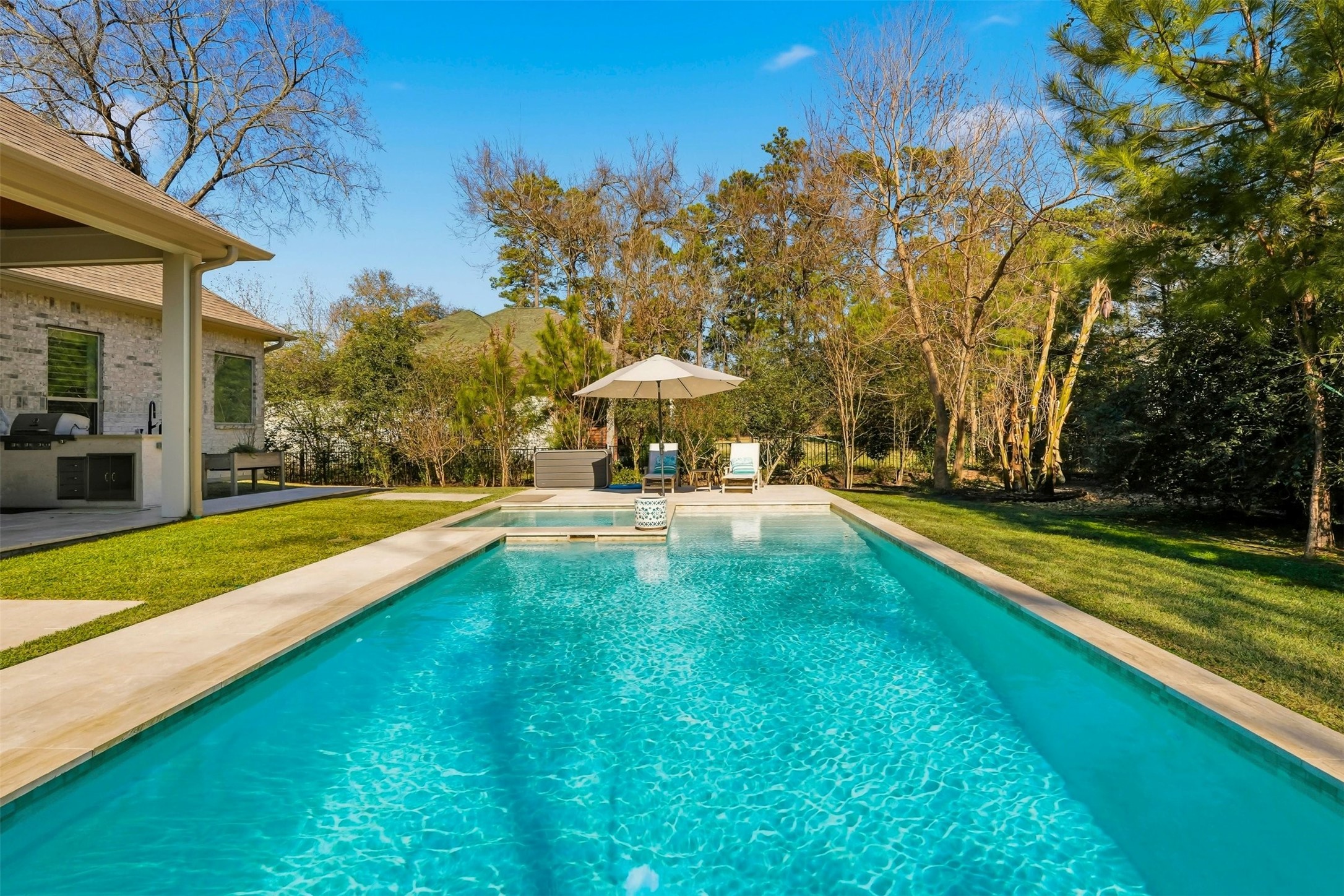 25202 Wilkes Park Road Tomball, TX 77375 - Photo 41 of 47 a view of swimming pool with lawn chairs under an umbrella