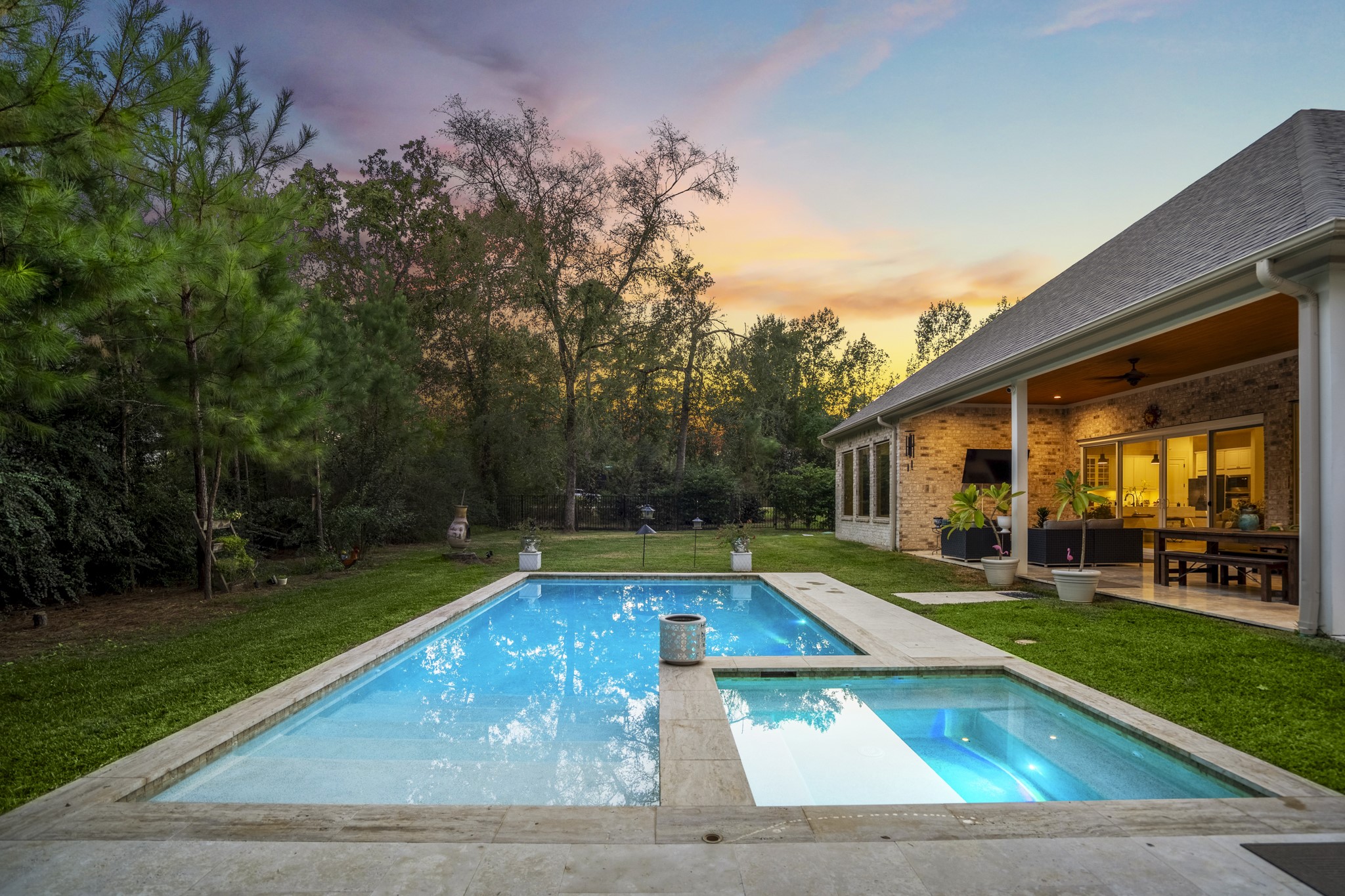 25202 Wilkes Park Road Tomball, TX 77375 - Photo 42 of 50 Resort-style pool with integrated hot tub offers a relaxing escape surrounded by mature trees and peaceful backyard privacy.