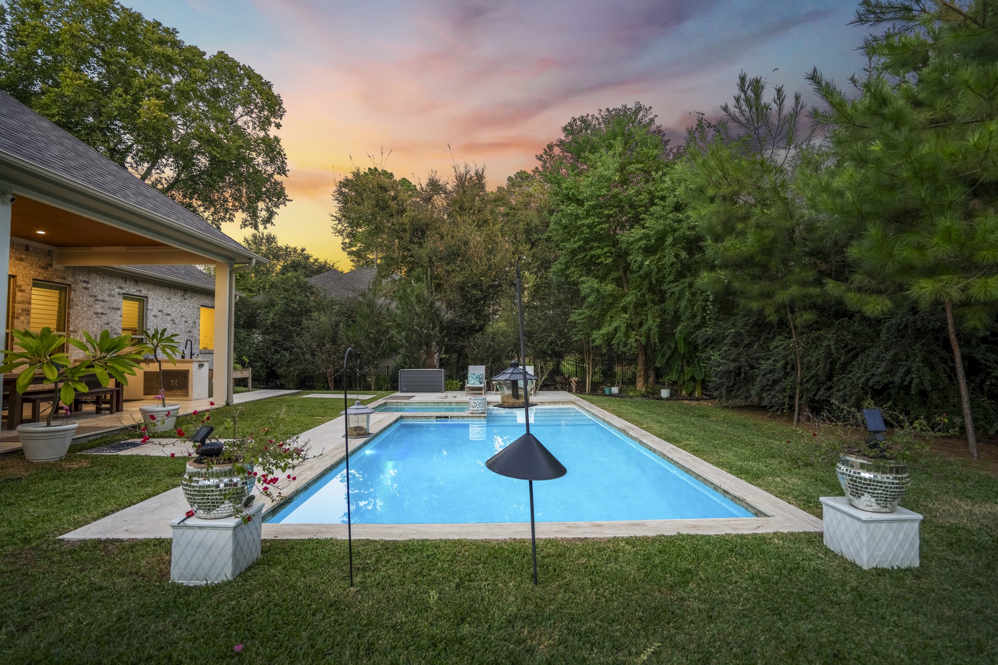 25202 Wilkes Park Road Tomball, TX 77375 - Photo 44 of 50 The seamless connection between pool and hot tub enhances the outdoor living experience, providing both relaxation and entertainment for all ages.