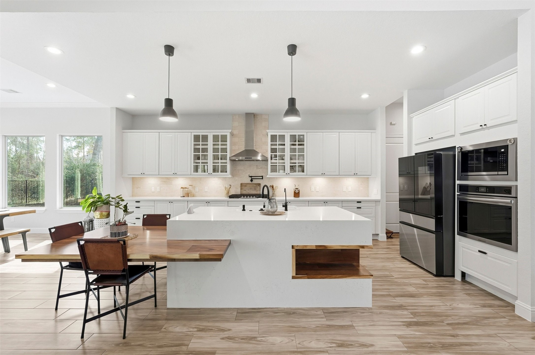 25202 Wilkes Park Road Tomball, TX 77375 - Photo 5 of 47 a view of a kitchen with kitchen island a stove a refrigerator a sink dishwasher with a dining table and chairs
