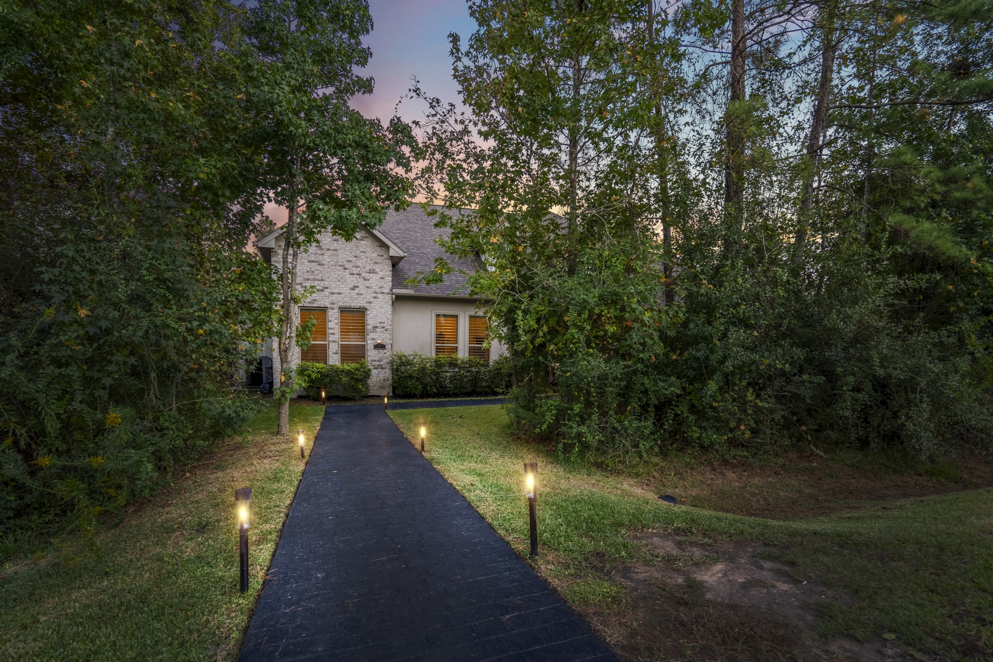 25202 Wilkes Park Road Tomball, TX 77375 - Photo 6 of 50 Thoughtfully planned landscaping with magnolias, hollies, ligustrum and flowering shrubs enhances privacy and curb appeal.