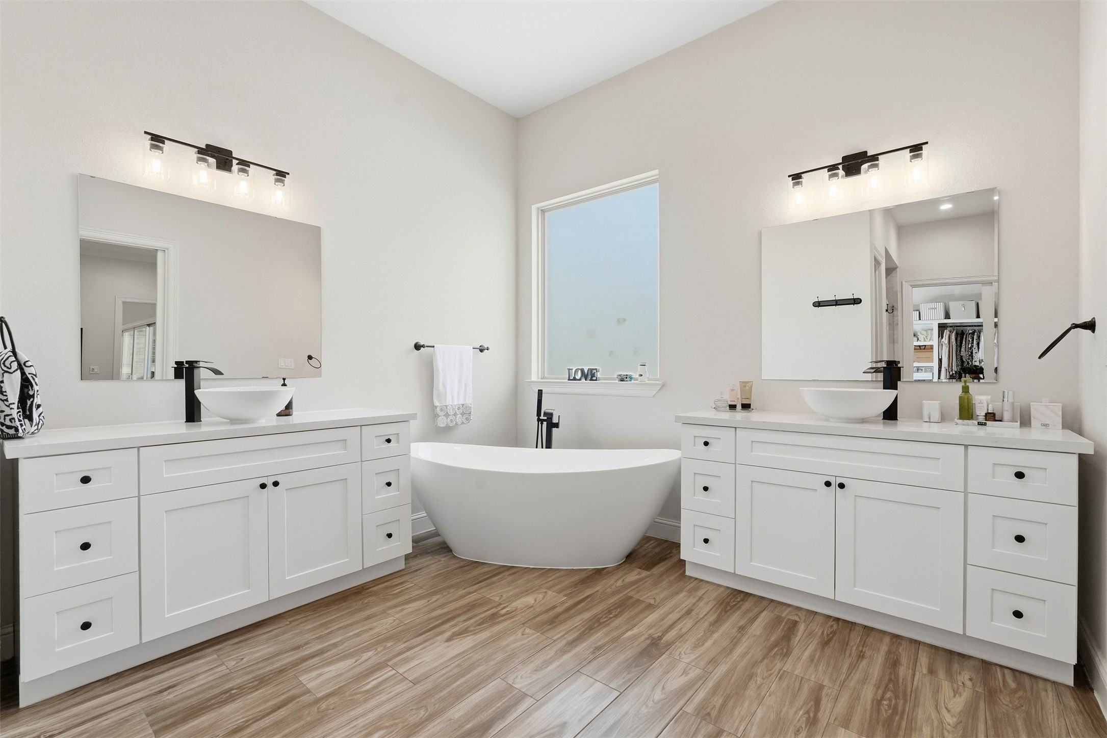 25202 Wilkes Park Road Tomball, TX 77375 - Photo 8 of 47 a spacious bathroom with double vanity sink a mirror and a bathtub