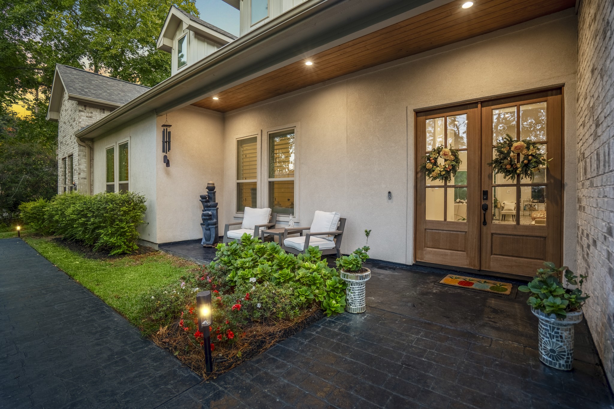 25202 Wilkes Park Road Tomball, TX 77375 - Photo 9 of 50 Welcoming front porch sheltered beneath a stained wood ceiling enhances comfort and design.