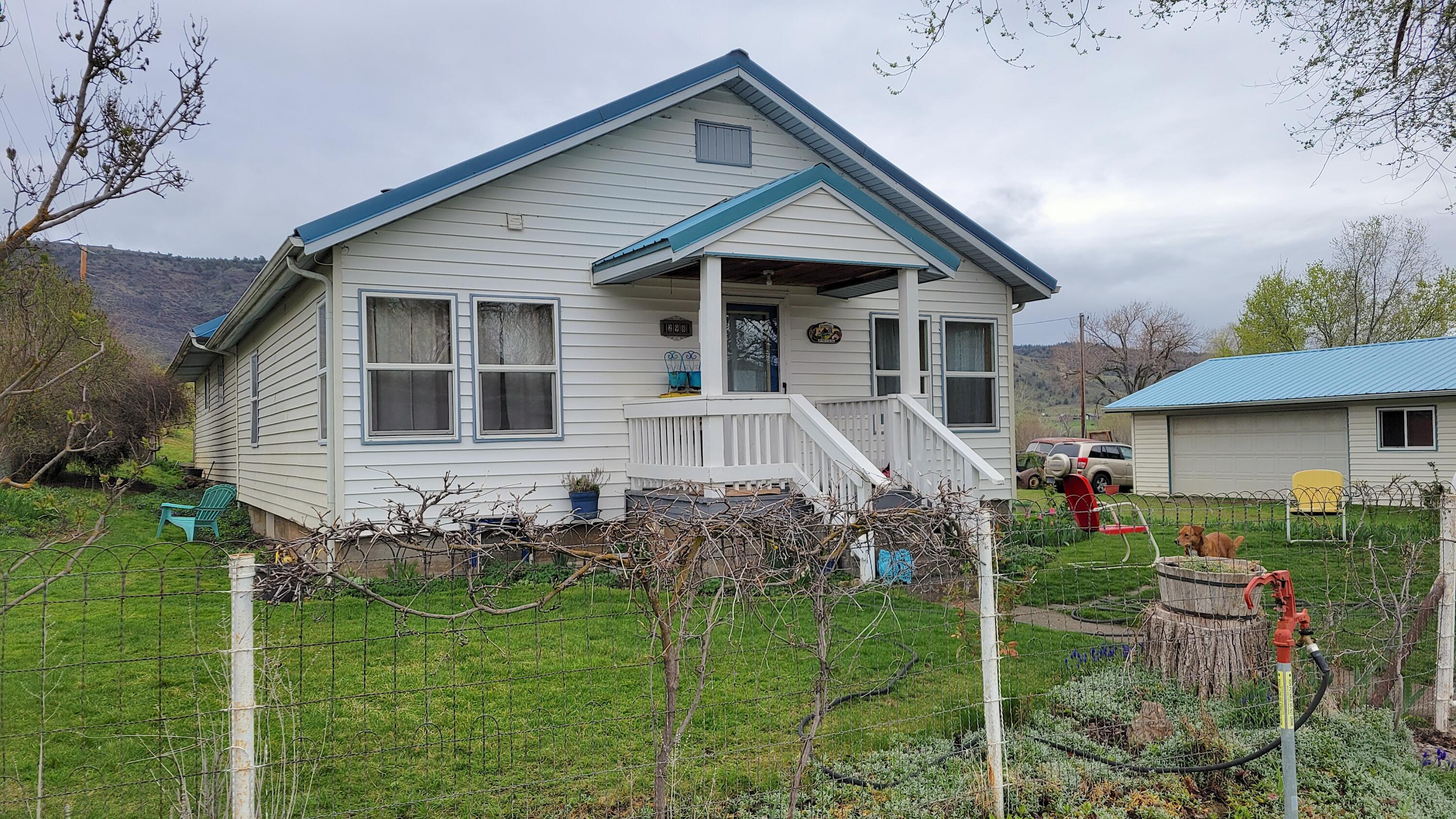 a front view of a house with a yard table and chairs
