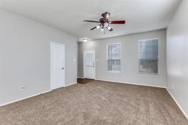 a view of an empty room with a fan