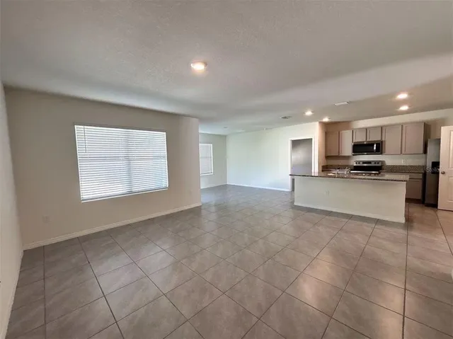 a view of a kitchen with microwave and cabinets