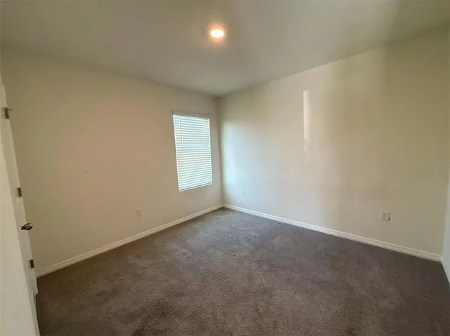 a view of an empty room with windows