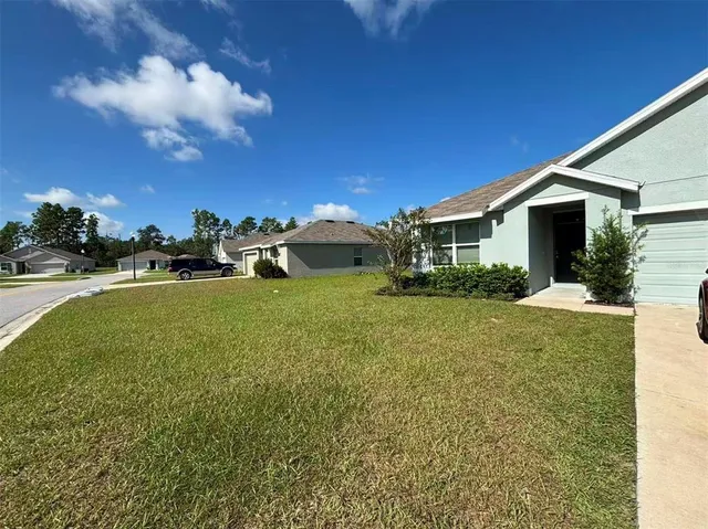 a view of a house with a yard porch and sitting area