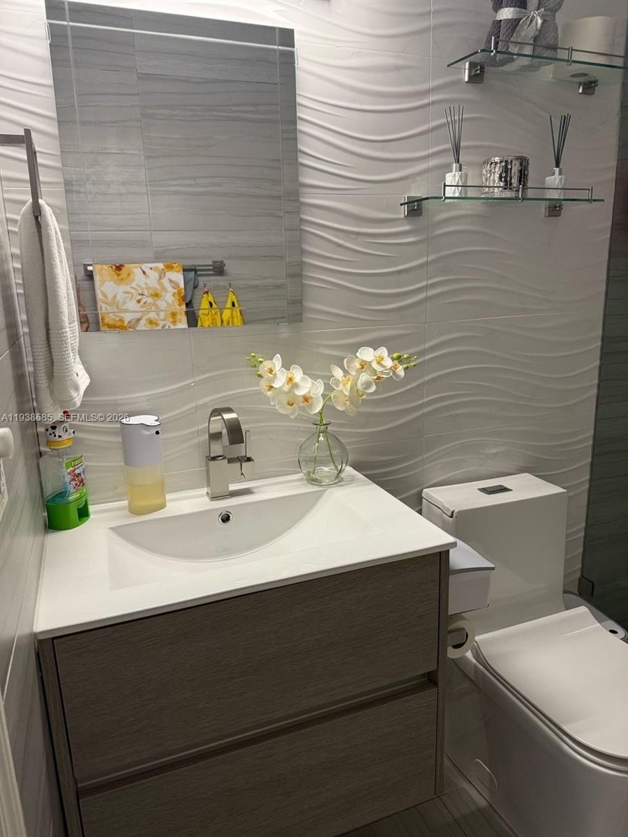 2837 West 75th Street Hialeah, FL 33018 - Photo 11 of 22 a bathroom with a sink toilet and mirror