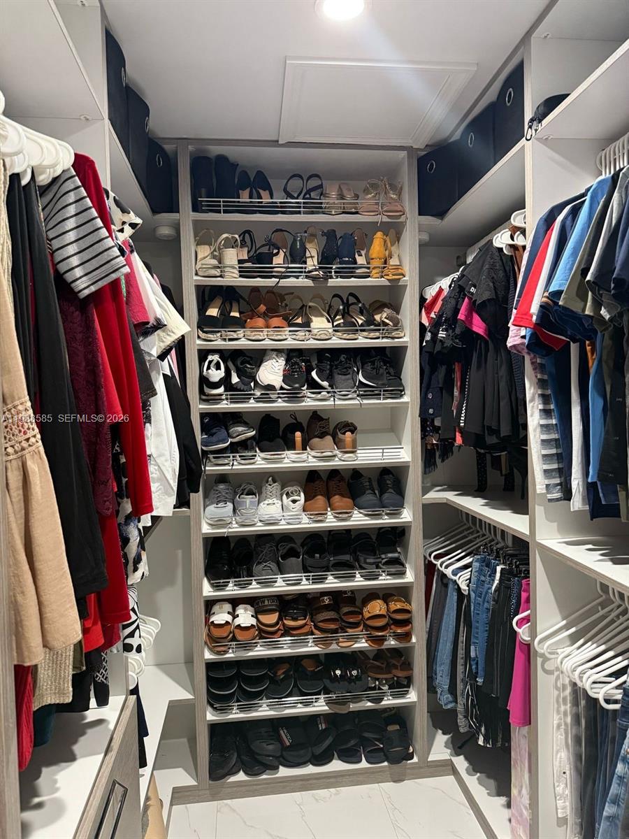 2837 West 75th Street Hialeah, FL 33018 - Photo 14 of 22 a view of walk in closet with clothes and shoes