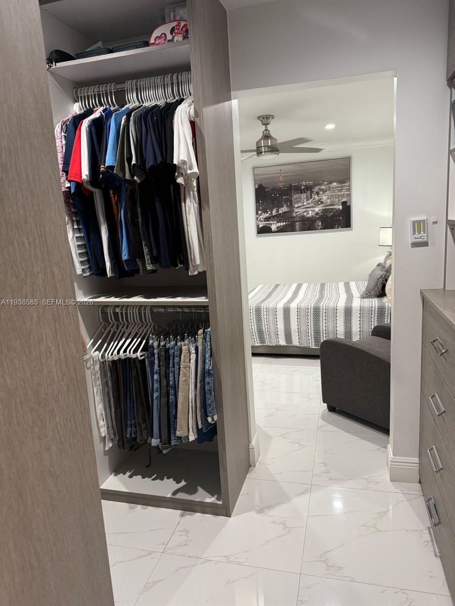 2837 West 75th Street Hialeah, FL 33018 - Photo 15 of 22 a view of walk in closet with clothes and shoes