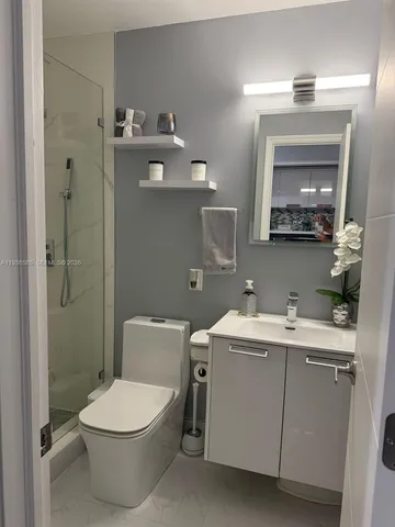 a bathroom with a toilet and a shower