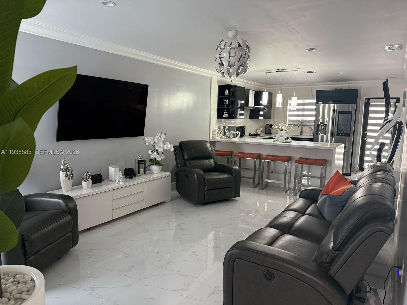 2837 West 75th Street Hialeah, FL 33018 - Photo 2 of 22 a living room with furniture and a flat screen tv