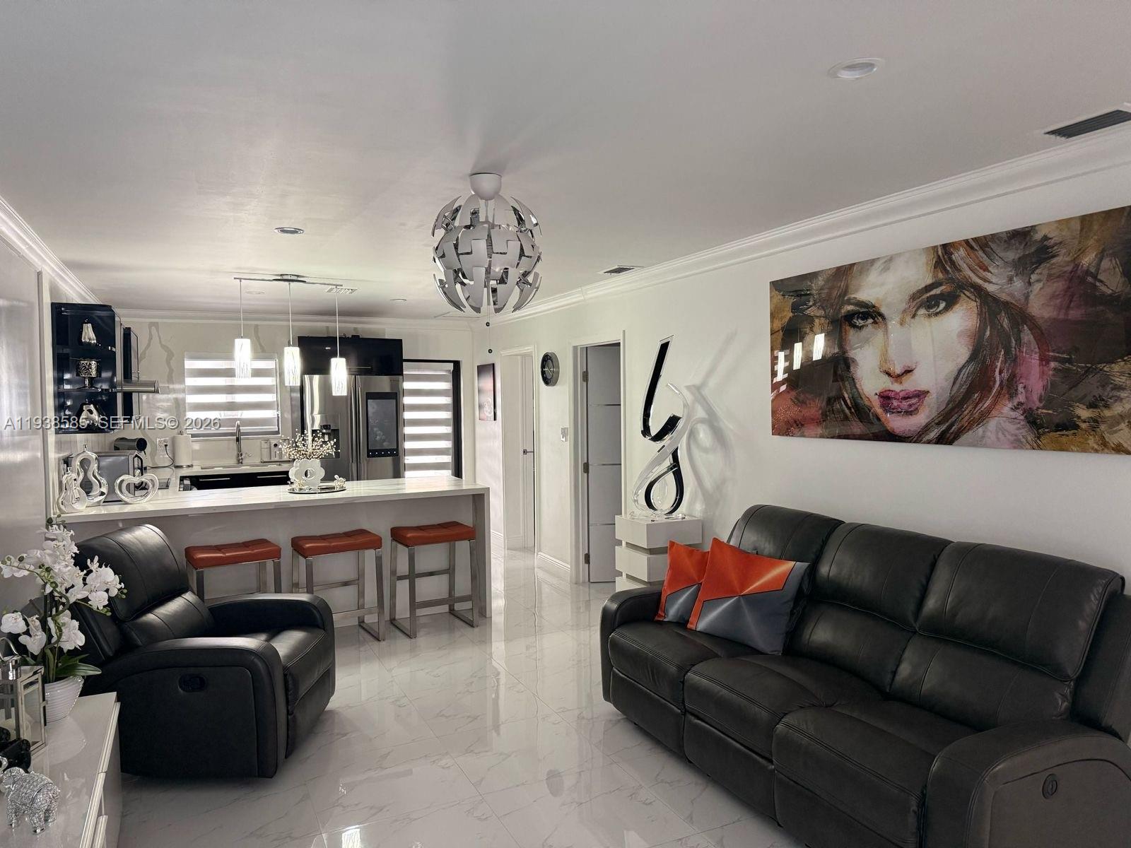 2837 West 75th Street Hialeah, FL 33018 - Photo 3 of 22 a living room with furniture a chandelier and a painting