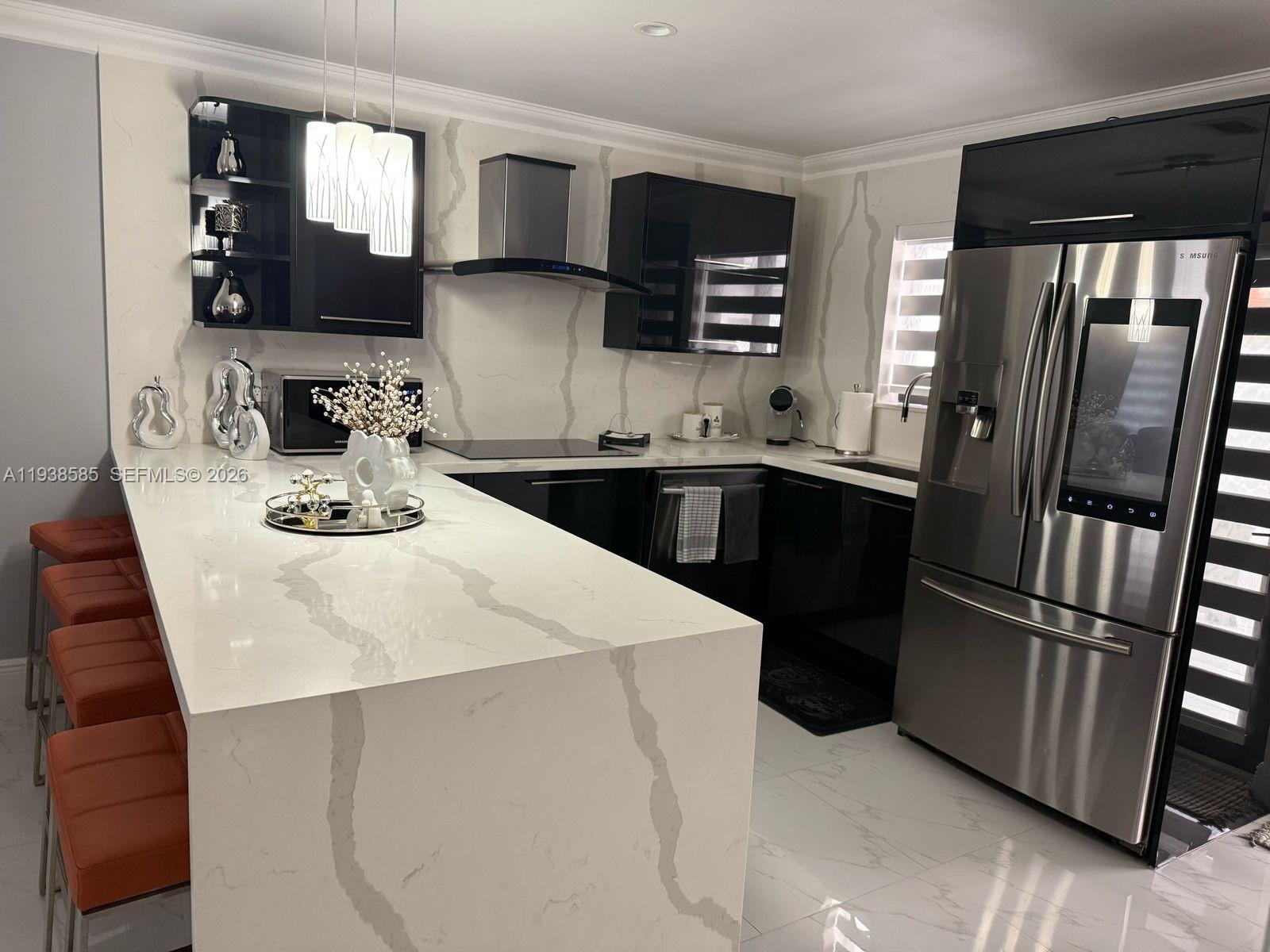 2837 West 75th Street Hialeah, FL 33018 - Photo 4 of 22 a kitchen with stainless steel appliances kitchen island granite countertop a refrigerator a sink a stove and cabinets