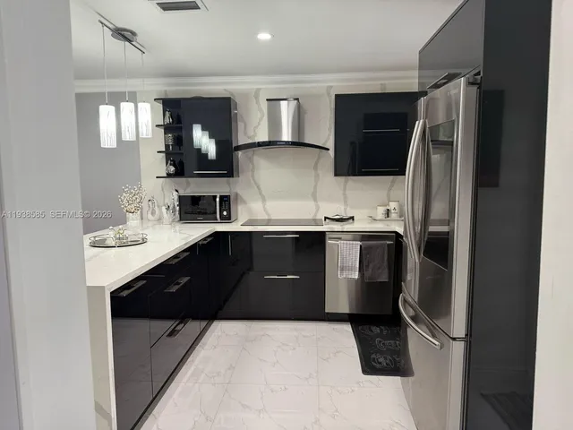 a kitchen with a sink stainless steel appliances and cabinets