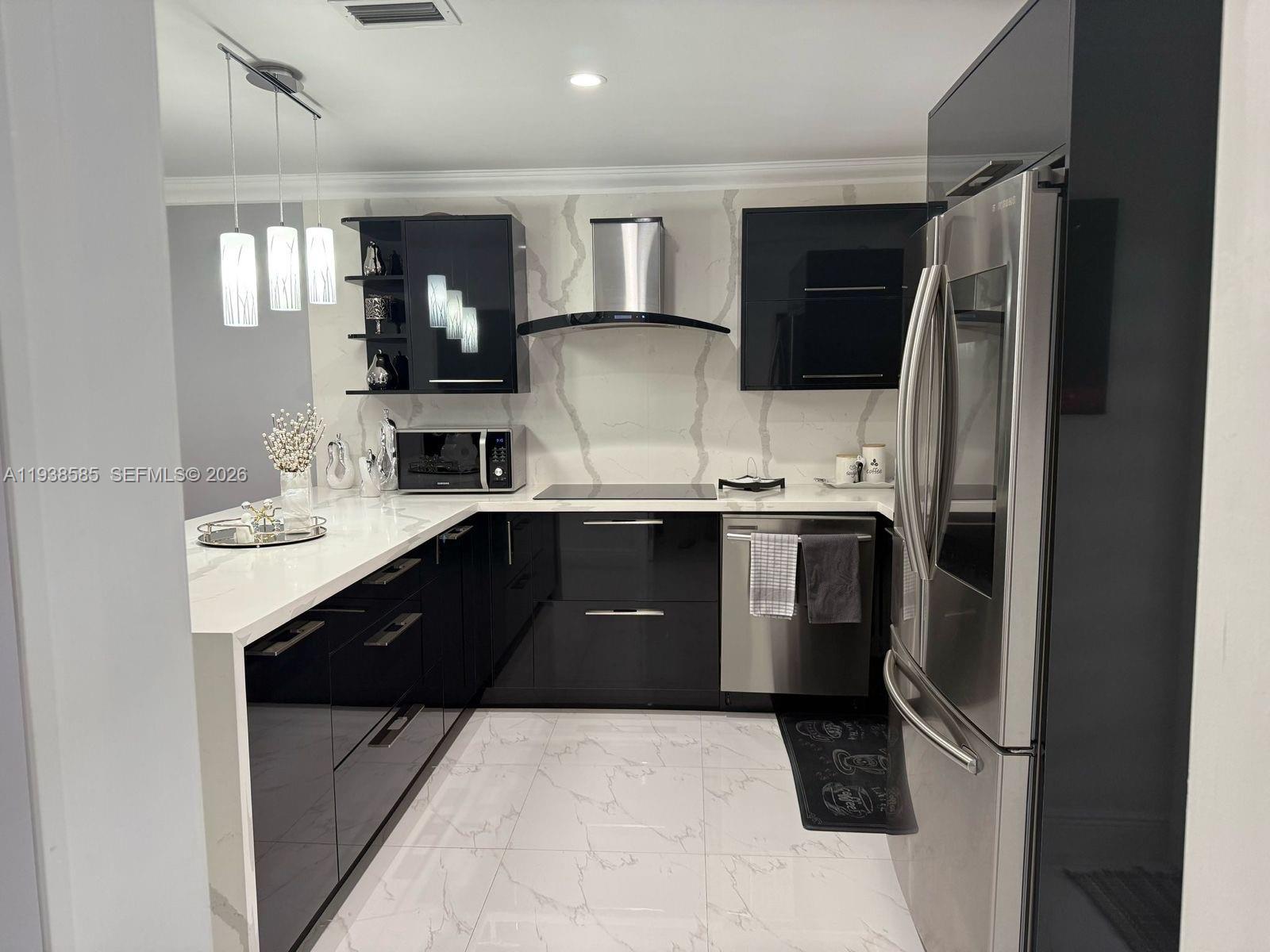 2837 West 75th Street Hialeah, FL 33018 - Photo 5 of 22 a kitchen with a sink stainless steel appliances and cabinets