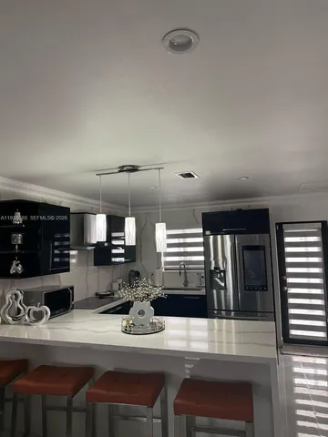 a kitchen with a table chairs stove and cabinets