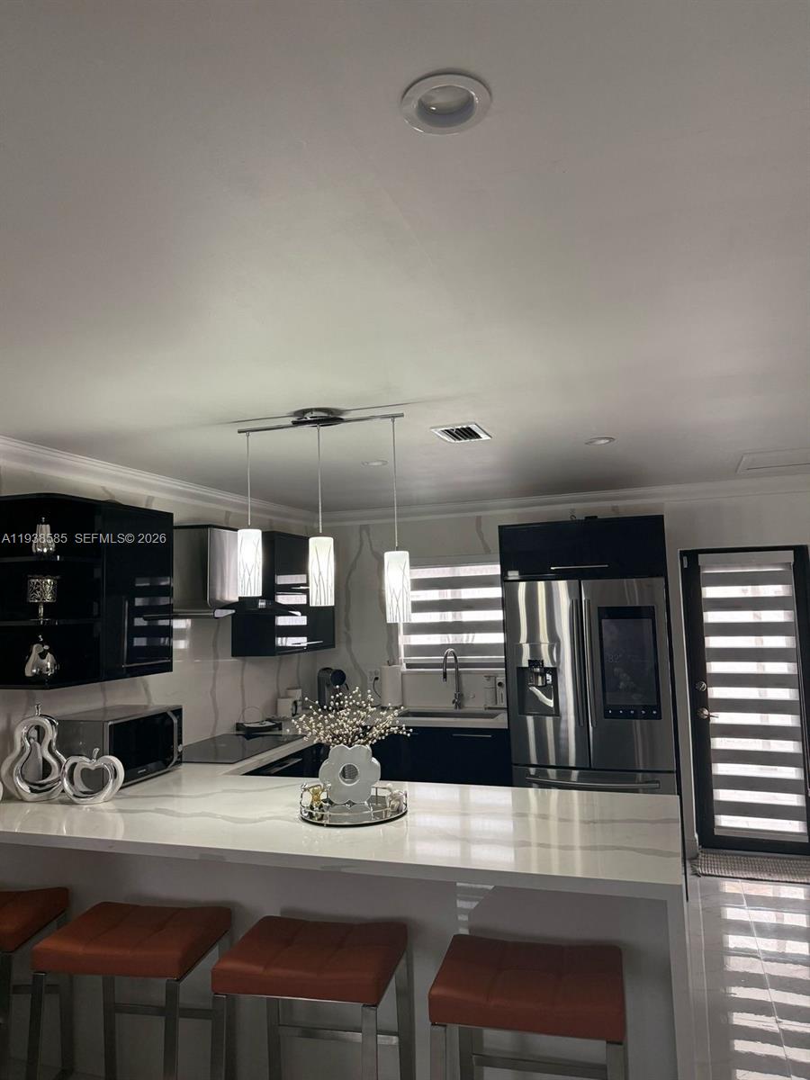 2837 West 75th Street Hialeah, FL 33018 - Photo 6 of 22 a kitchen with a table chairs stove and cabinets